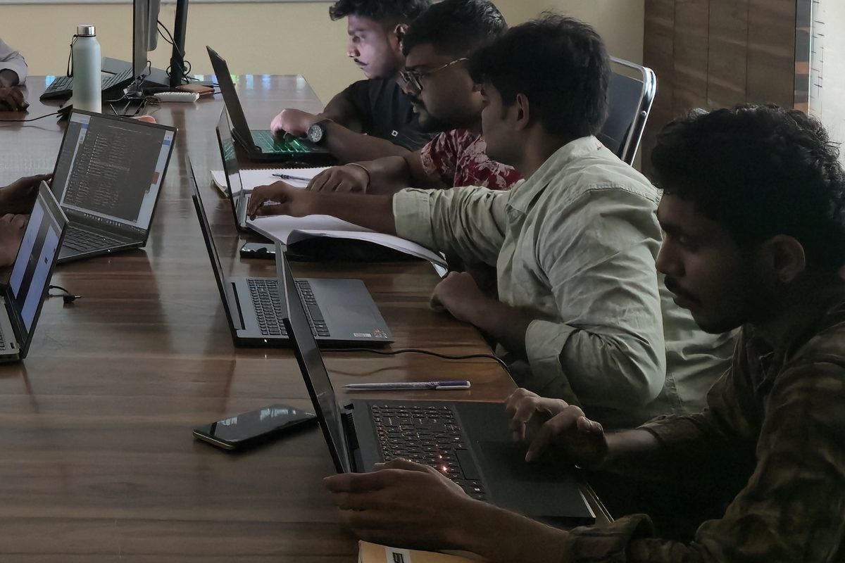 Students typing on laptops during a hands-on lab in the Ameerpet training room